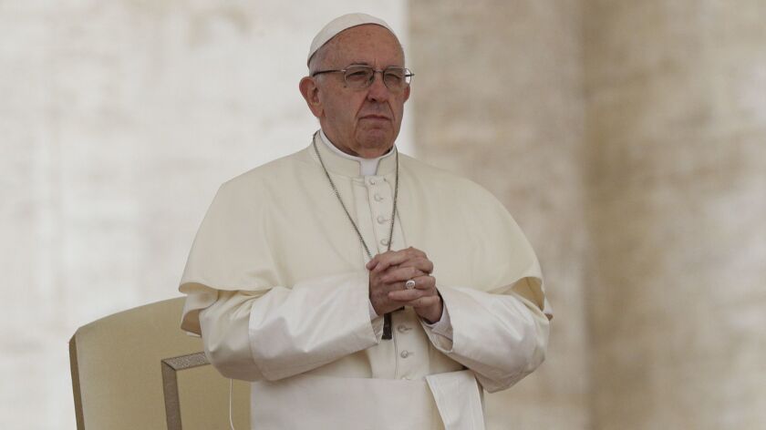 Pope Francis prays during his weekly general audience in St. Peter's Square at the Vatican on May 2.