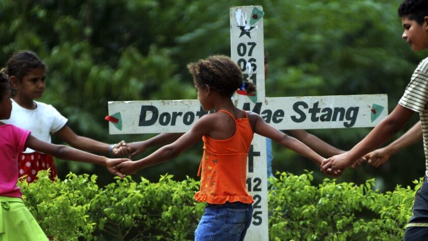 Children play next to the place where American nun Dorothy Stang was killed in Anapu, Brazil, in Nov