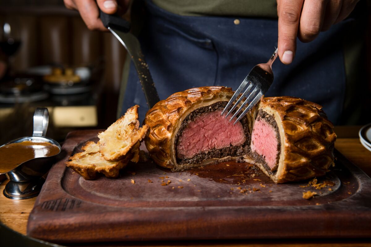 Beef Wellington carved tableside at Born and Raised restaurant in Little Italy.