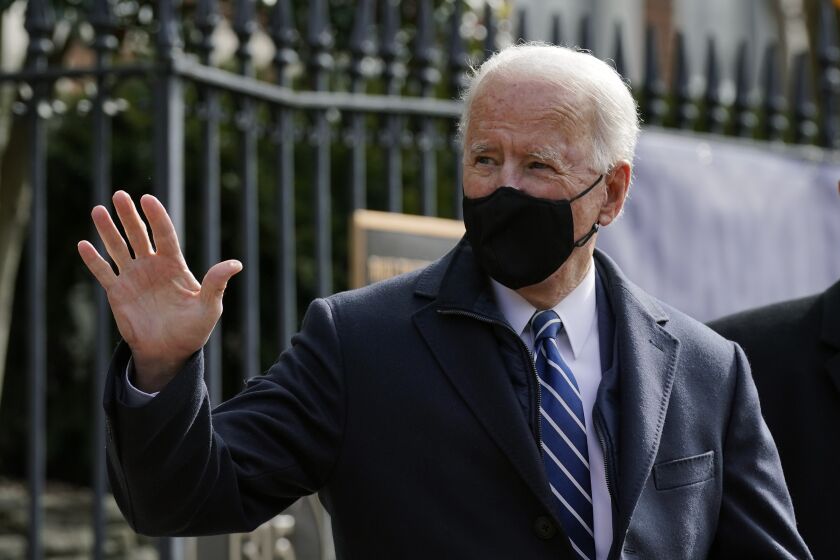 President Joe Biden waves as he departs after attending Mass at Holy Trinity Catholic Church, Sunday, Jan. 24, 2021, in the Georgetown neighborhood of Washington. Biden plans to sign an executive order Monday, Jan. 25 that aims to boost government purchases from U.S. manufacturers. (AP Photo/Patrick Semansky)