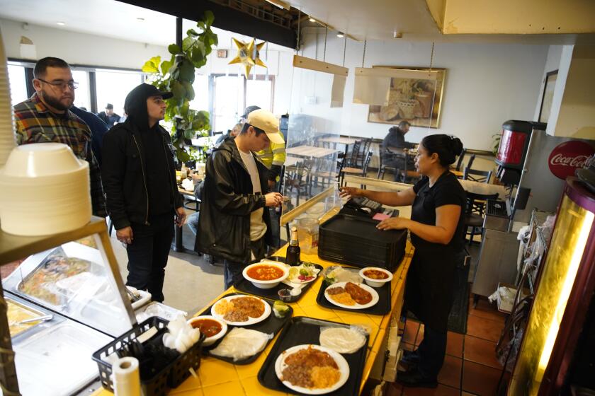 San Diego, California - December 22: Super Cocina restaurant was established in 1988 its the most authentic cooking from the Mexican heartland. Customers paying for their meals in City Heights on Friday, Dec. 22, 2023 in San Diego, California. (Alejandro Tamayo / The San Diego Union-Tribune)