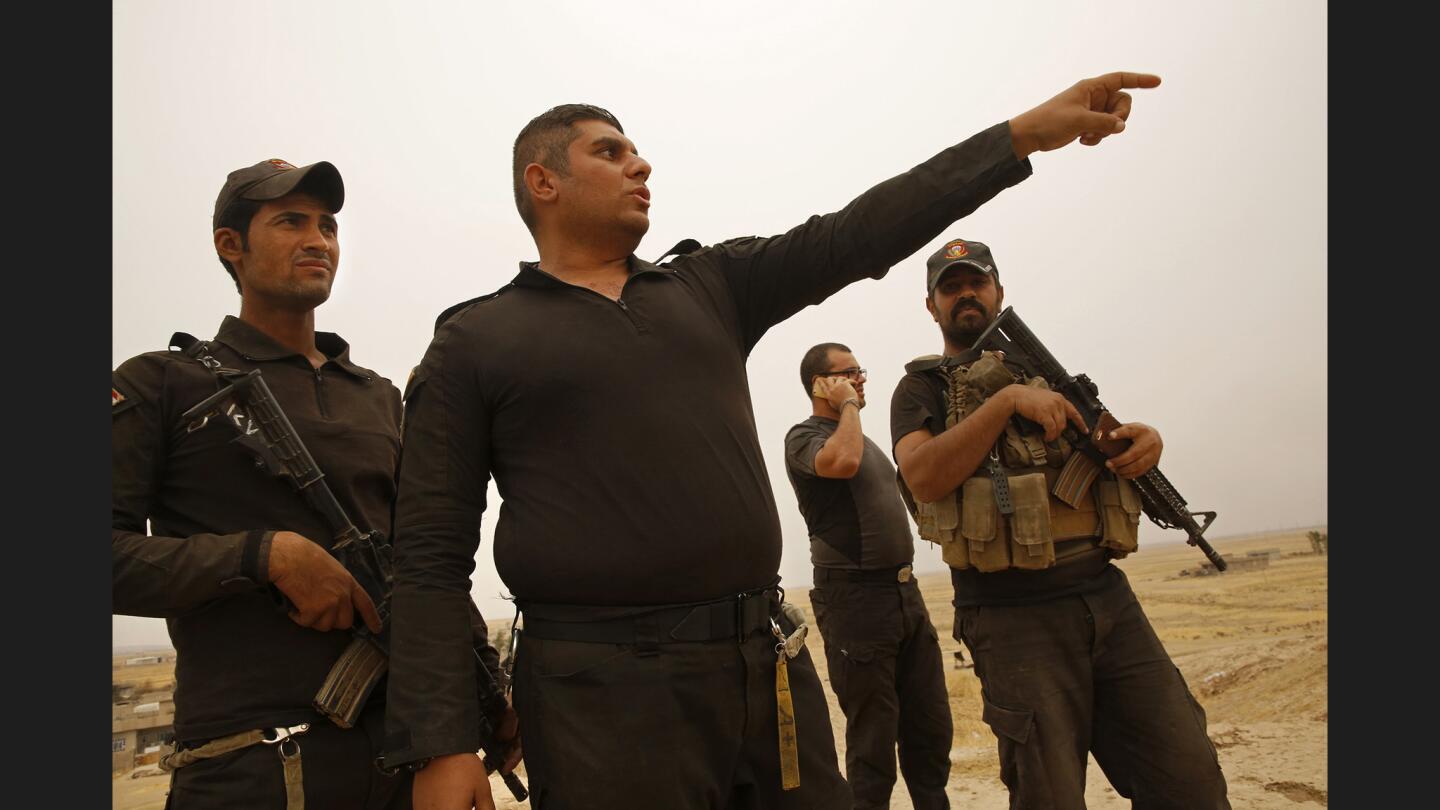 Lt. Col. Ali Hussein Fadil, center,commands an Iraqi special forces unit in the fight to retake the city of Mosul, including 28-year-old Waleed Abdel Nabi, left.