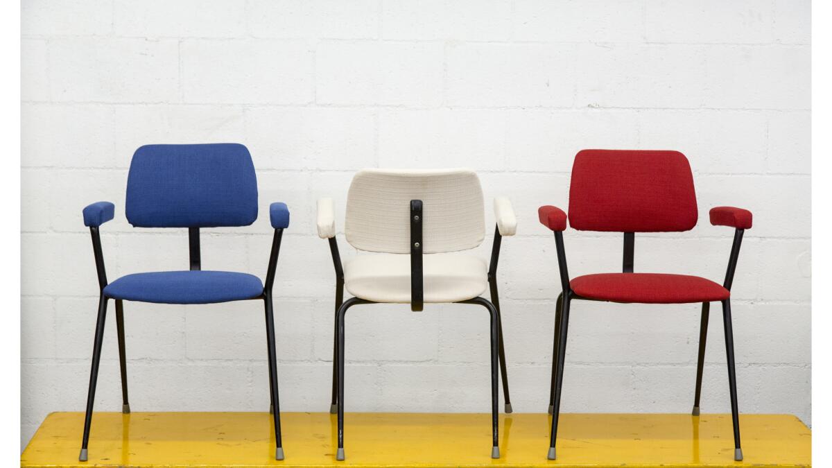 Stacking upholstered industrial arm chairs by Cox / England. Tubular stacking chairs with upholstered seat, Back and arm rests at Amsterdam Modern.