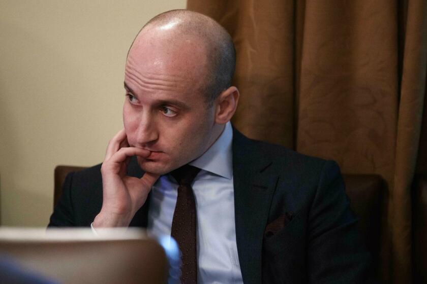 FILE- In this Jan. 2, 2019, file photo White House senior adviser Stephen Miller listens as President Donald Trump speaks during a cabinet meeting at the White House in Washington. Miller indicated Sunday, Feb. 17, on "Fox News Sunday" that Trump is prepared to issue the first veto of his term if Congress votes to disapprove of his declaration of a national emergency along the U.S.-Mexico border. (AP Photo/Evan Vucci, File)