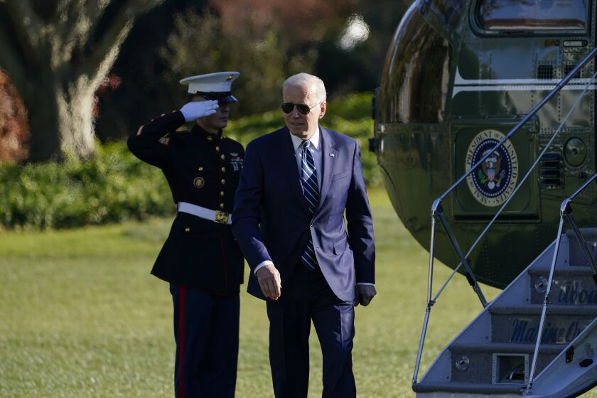President Joe Biden walks off of Marine One on the South Lawn of the White House in Washington, Friday, Nov. 19, 2021, after returning from Walter Reed National Military Medical Center for his annual physical. (AP Photo/Susan Walsh)