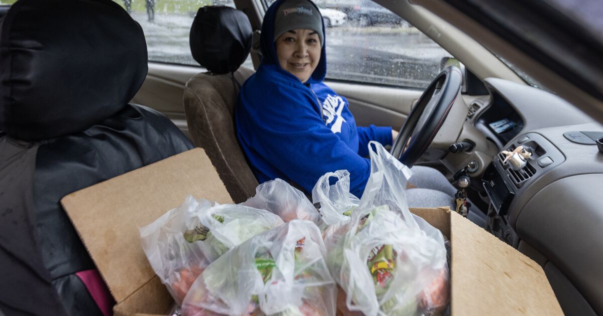 Parents brave the rain to secure three days of food for their children