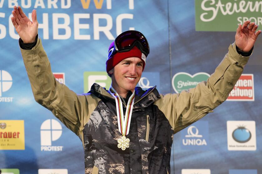 Kyle Smaine from the U.S. celebrates his gold medal at the men's freestyle ski half pipe event.