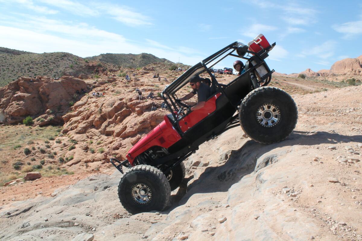 An off-roader and his family descend Potato Salad Hill outside Moab, Utah.