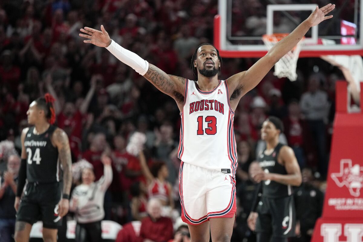 Houston forward J'Wan Roberts (13) reacts after a Cincinnati shot clock violation during the second half of an NCAA college basketball game, Saturday, Jan. 28, 2023, in Houston. (AP Photo/Eric Christian Smith)