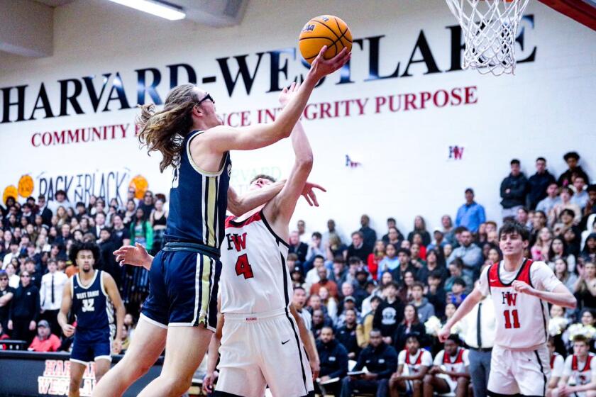 Andrew Meadow of West Ranch goes up for shot against Harvard-Westlake's Nikolas Khamenia.
