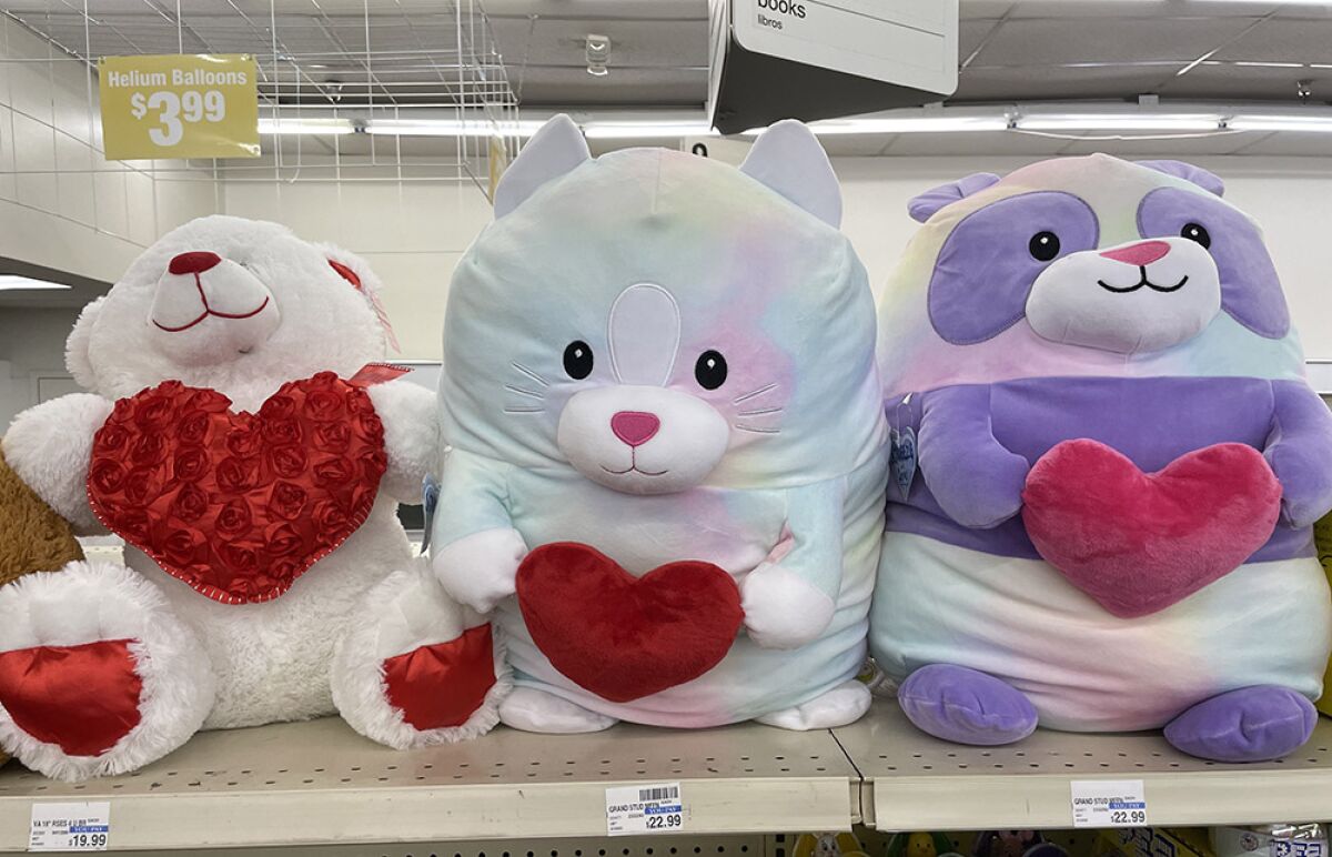 Three stuffed bears holding hearts