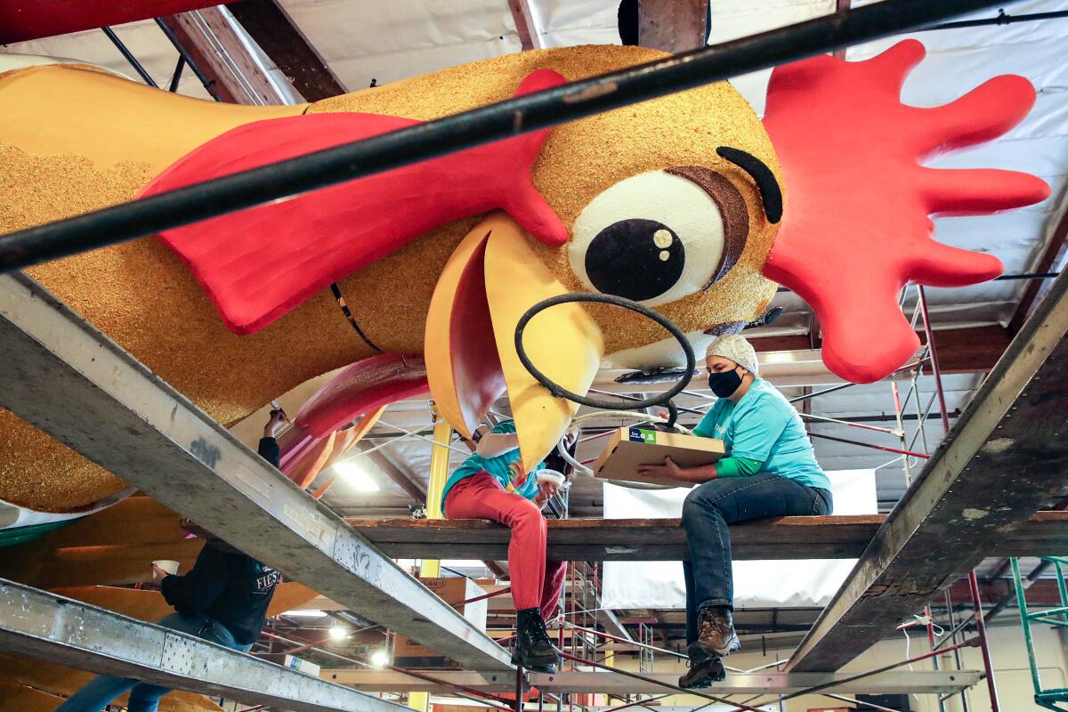 Volunteers work a float for upcoming 2022 Rose Parade.