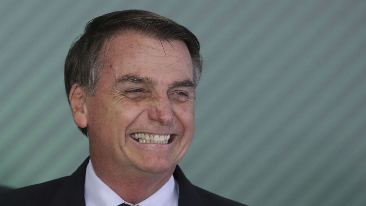 Brazilian President Jair Bolsonaro attends a ceremony at Planalto presidential palace in Brasilia, where he signed a decree Jan. 15, 2019, loosening restrictions on owning a firearm.