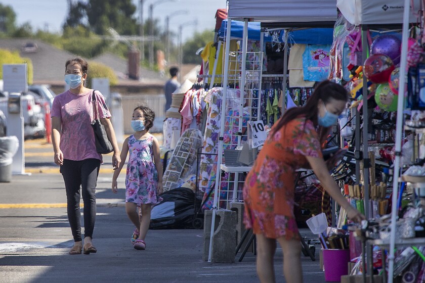 California moves to rescind dozens of emergency COVID-19
actions as reopening nears 6 WESTMINSTER, CA - AUGUST 05: Shoppers and store owners wear mask to protect themselves and others from contracting COVID-19 at the Asian Garden Mall, which is closed to indoor shopping but some shops are open outdoors under tents on Wednesday, Aug. 5, 2020 in Westminster, CA. In Little Saigon in Orange County, the low number of coronavirus cases and deaths is the result of cultural habits and "consistent" behavior, according to experts and immigrants themselves. They cite three reasons: The Vietnamese are "more disciplined" in following CDC guidelines based on deep reverence for the medical profession. They already are used to wearing masks in the homeland to avoid spreading common illnesses and to protect users from dust and fumes while zipping around on mopeds, a primary method of transportation. And within extended families, people tend to appoint a representative who is the only person to venture outside buying groceries, running errands or attending to urgent matters. Dr. Quynh Kieu and her assistants - she is a pediatrician who led a major project testing about 2,000 Vietnamese American patients from May to July, resulting in just 8 positive cases. (Allen J. Schaben / Los Angeles Times)