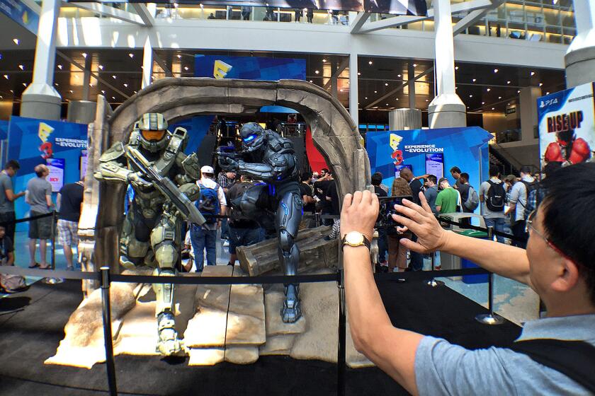 A man records a display for "Halo 5: Guardians" during the first day of E3 at the L.A. Convention Center.