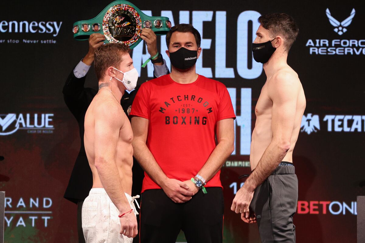Canelo Alvarez, left, and Callum Smith face off during their weigh-in in San Antonio, Texas, on Friday.