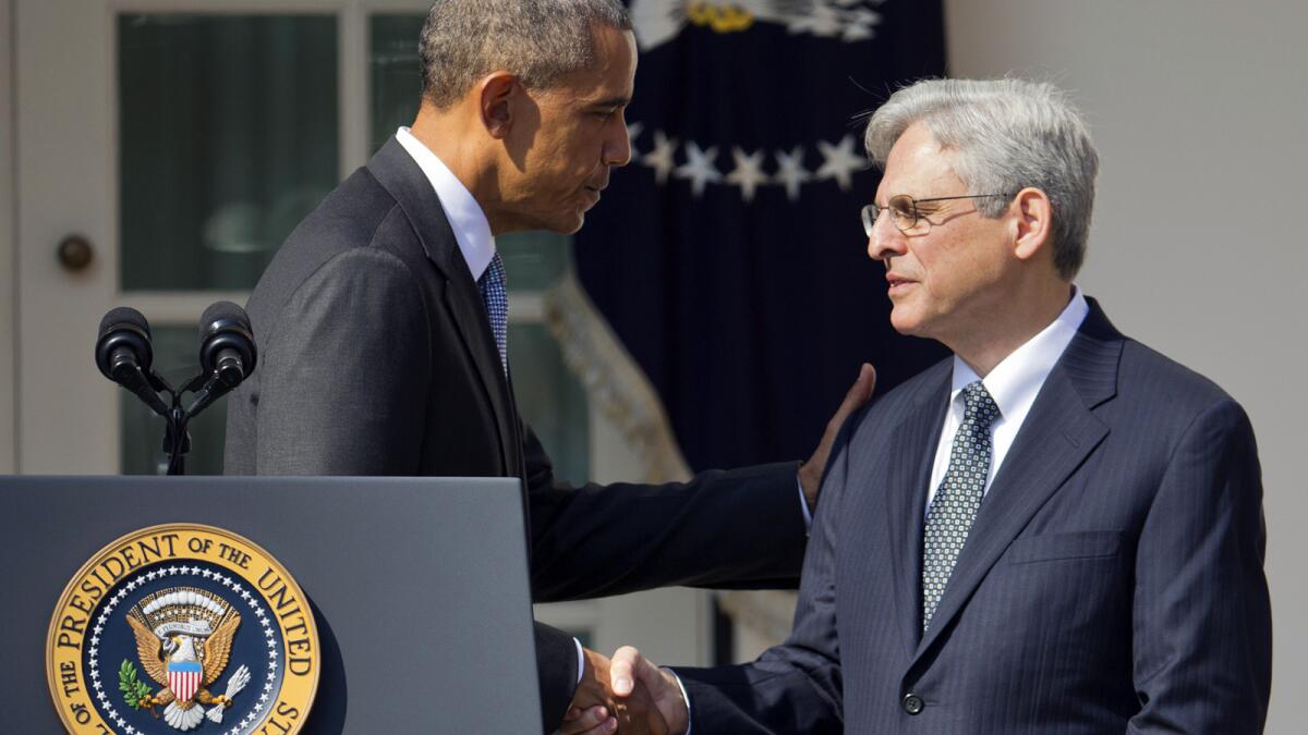Federal appeals court judge Merrick Garland shakes hands with President Obama as he is introduced as his nominee for the Supreme Court during an announcement in the White House Rose Garden.