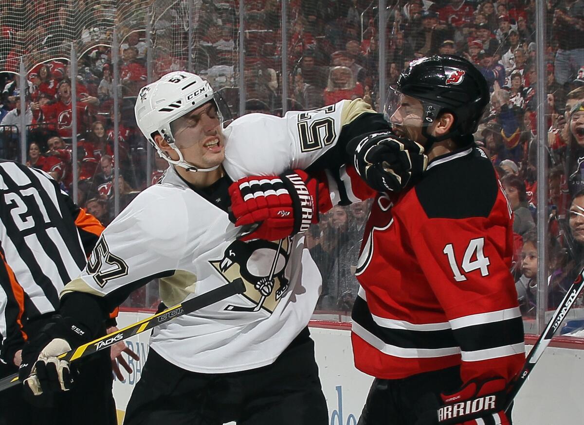 The Penguins have been a frustrated team as of recent. Here forward David Perron shoves the Devils' Adam Henrique in the face during a confrontation.
