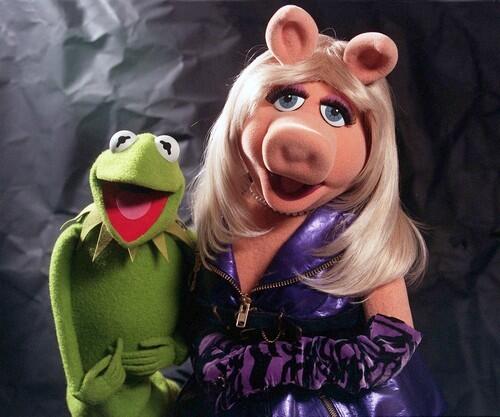 Miss Piggy Kermies beloved girlfriend  the piggy diva who was voiced primarily by Frank Oz  first appeared on the 1974 ABC special Herb Albert and the TJB, singing I Cant Give You Anything But Love. But Miss Piggy was destined to become a superstar. When The Muppet Show premiered in 1976, she didnt have a name, but she certainly had the look  big blue eyes, big bosom and blond hair. Though in love with Kermit, she isnt above giving him a karate chop  she even holds a pink belt in Pig Wan Do  any time she believes she has been insulted. She became a major player in Hollywood in the late 1970s and 80s and even took a pen to her hoof writing a best-seller. Miss Piggy has appeared in several of the Muppet feature films, and even played all four witches in the 2002 TV movie, The Muppets' 'Wizard of Oz.'  She hasnt changed much over the last three decades. But shes been uncharacteristically mum if shes had any cosmetic surgery.