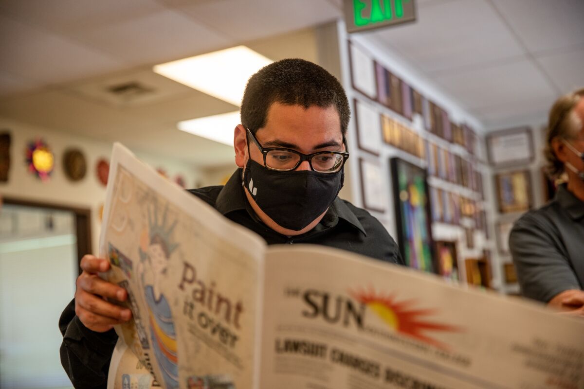 Senior staff writer Andrew Penalosa goes through The Southwestern College Sun newspaper on Tuesday, May 4, 2021.