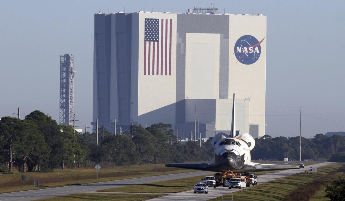 The Vehicle Assembly Building (with the space shuttle Atlantis in the foreground) at the Kennedy Space Center in Titusville, Fla.