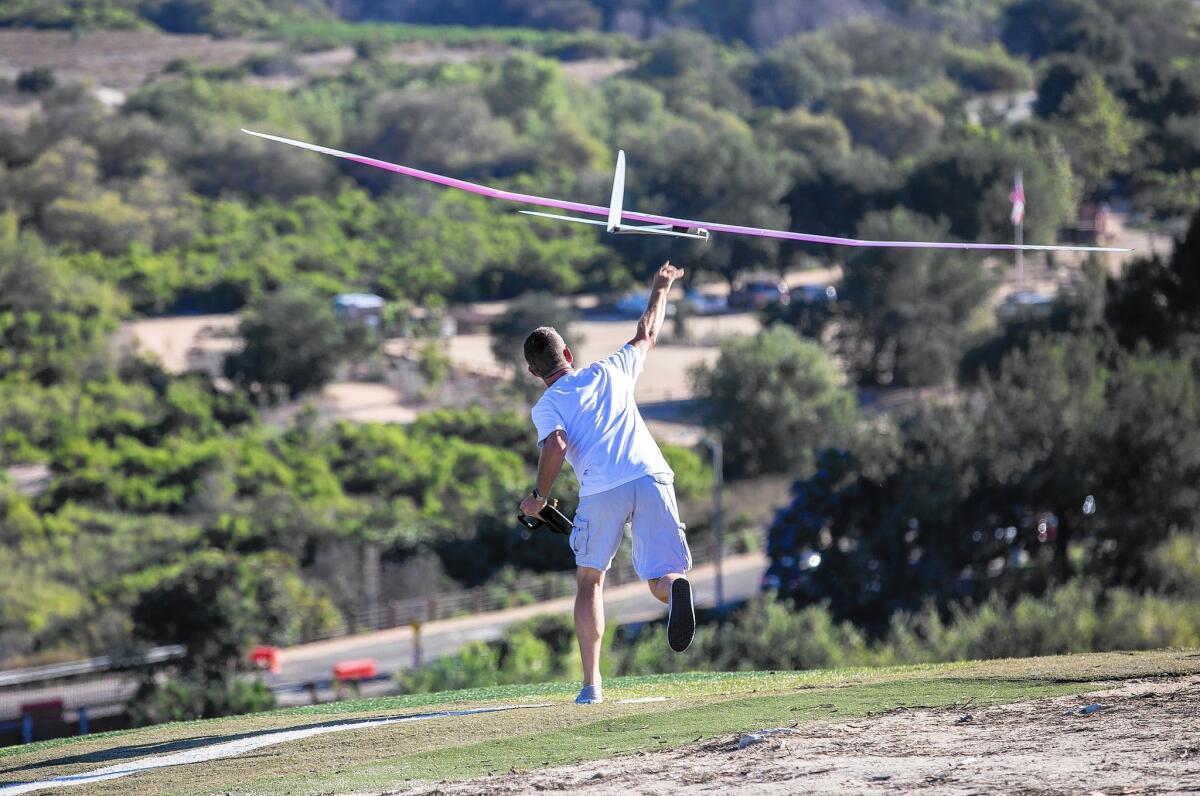 Scott Magner launches his aerodynamic glider off Kite Hill in Laguna Niguel. High-tech gliders like this one can reach speeds over 500 mph under the right wind conditions.