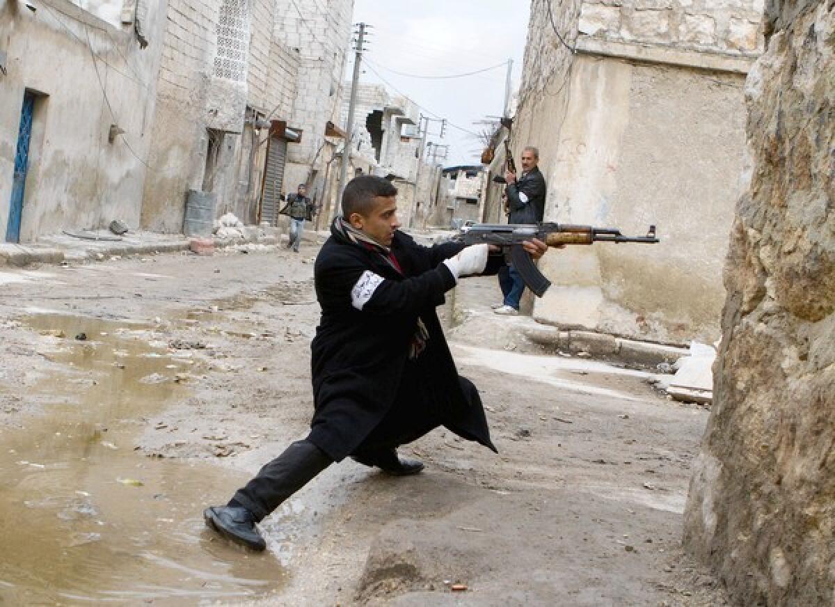 A Syrian rebel takes aim during clashes with government forces near the city of Aleppo.