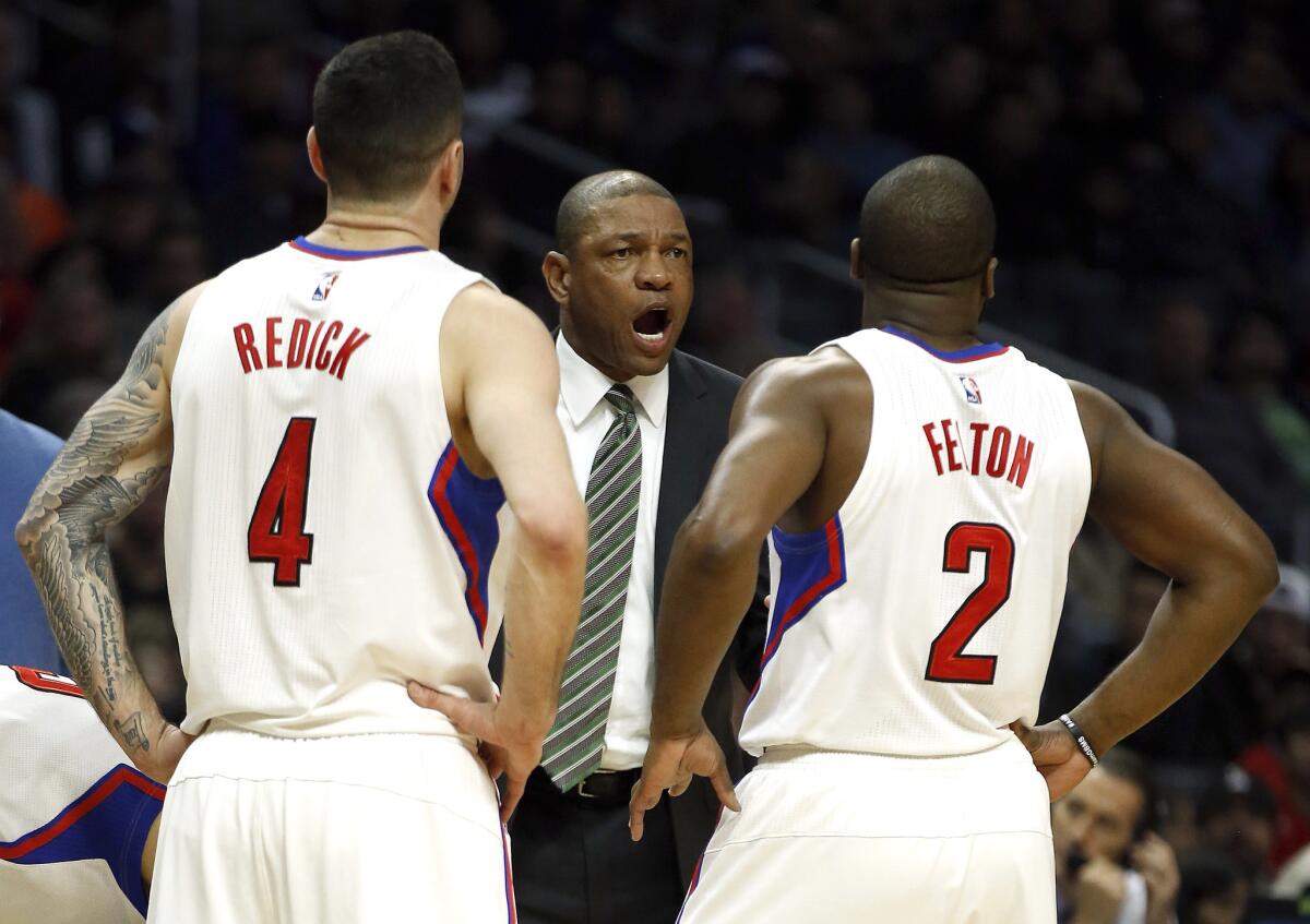 Clippers Coach Doc Rivers huddles with J.J. Redick, left, and Raymond Felton during a game against Phoenix on Jan. 2.