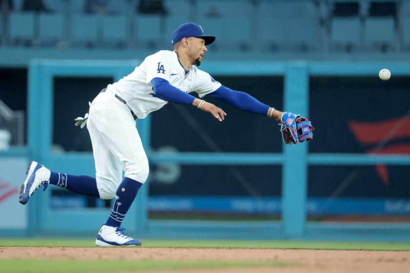 LOS ANGELES, CALIFORNIA May 9, 2024- Dodgers shortstop Mookie Betts can't reach a single by Diamondbacks Randal Grichuk in the second inning at Dodger Stadium Wednesday. (Wally Skalij/Los Angeles Times)
