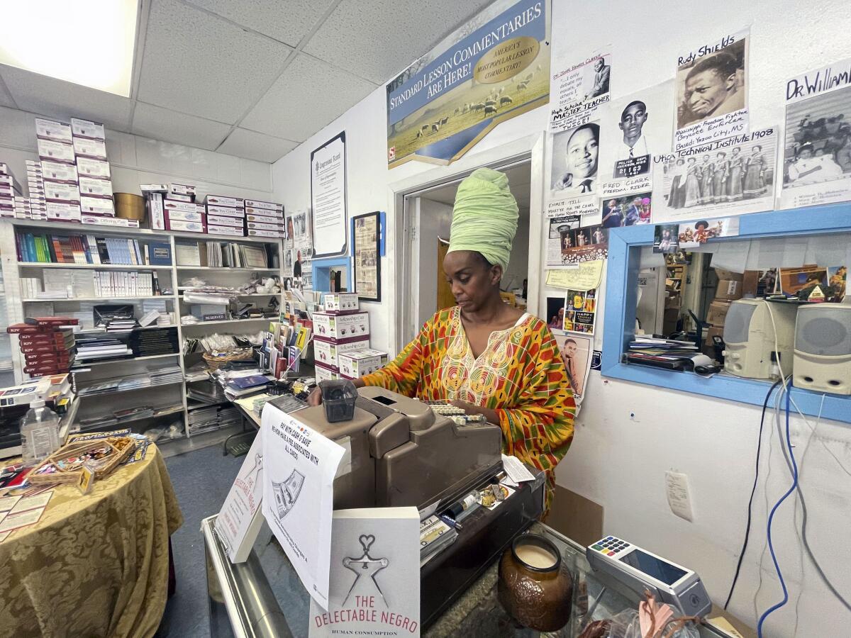 Maati Jone Primm looks down at her notes in her store Marshall's Music and Bookstore in Farish Street Historic District, Thursday, Sept. 1, 2022 in Jackson, Miss. She said white flight is at the root of Jackson's water woes. (AP Photo/Michael Goldberg)