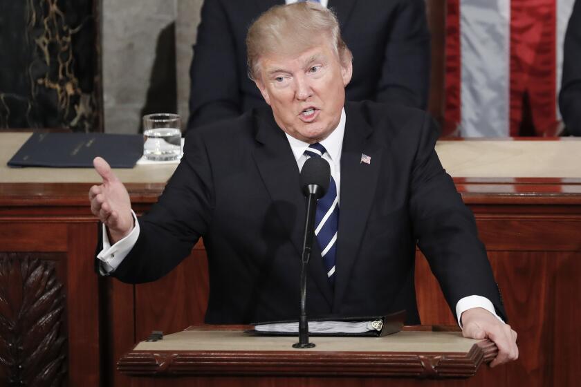 President Donald Trump gestures towards democrats while addressing a joint session of Congress on Capitol Hill