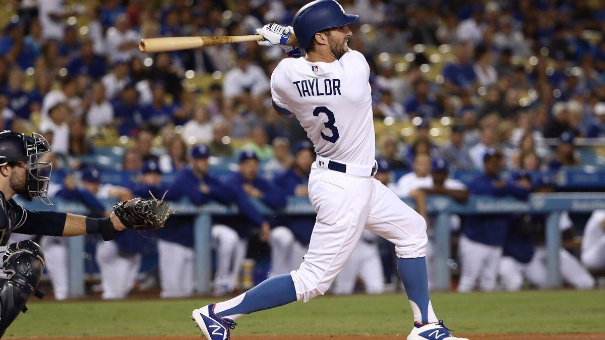 The Dodgers' Chris Taylor doubles to deep center field in the first inning Monday against the San Diego Padres at Dodger Stadium.