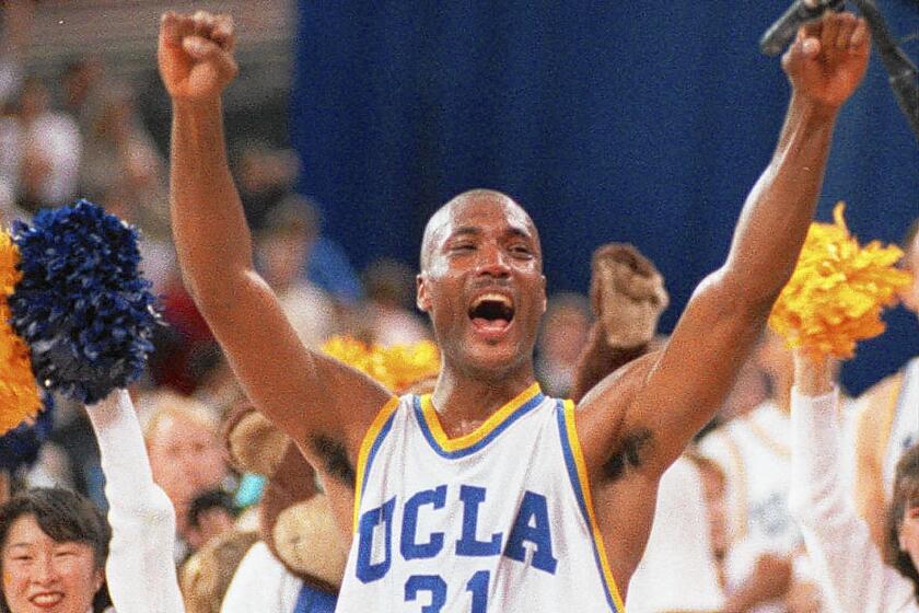 Ed O'Bannon celebrates UCLA's NCAA championship in 1995. A lawsuit led by O'Bannon argues that some student athletes should receive a share of the TV contracts and video-game endorsement deals the NCAA generates by using their names, images and likenesses.
