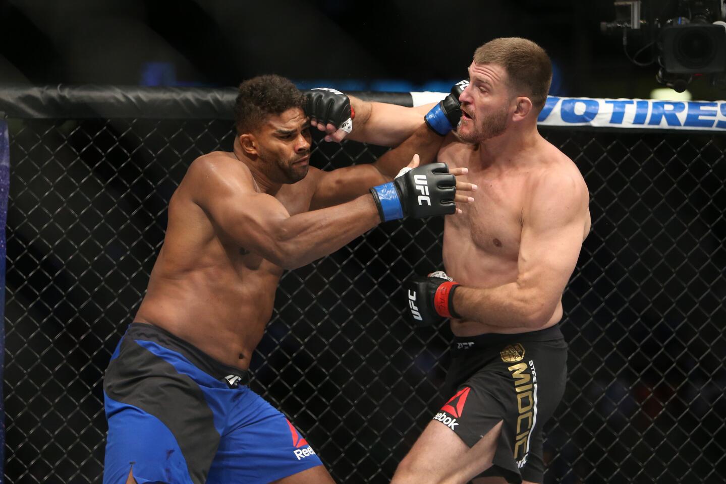 Stipe Miocic, right, punches Alistair Overeem at Sept. 10 at UFC 203 in Cleveland.