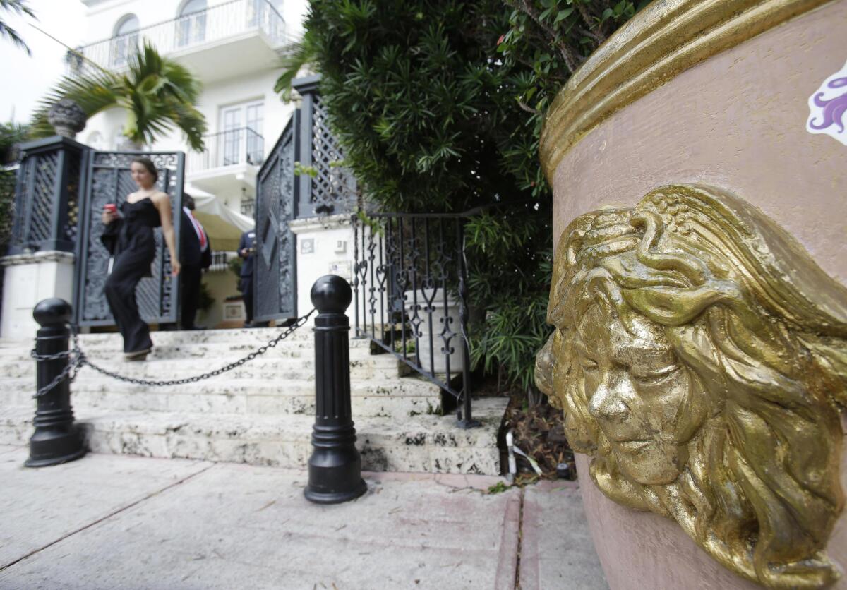 FILE - In this Sept. 17, 2013, file photo, the Versace logo is shown on a planter outside of the South Beach mansion that once belonged to Gianni Versace in Miami Beach, Fla. Two men apparently killed themselves, police said, Thursday, July 15, 2021, in a suite at the Miami Beach hotel that Gianni Versace turned into his mansion, nearly 24 years to the day before the fashion designer died on the building's front steps. Their bodies were found by housekeeping on Wednesday, the eve of the anniversary of Versace's slaying by a suspected serial killer. (AP Photo/Wilfredo Lee)