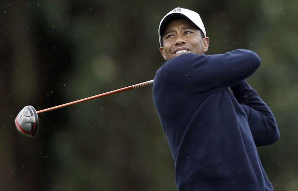 Tiger Woods follows through on his tee shot at No. 15 on Friday during the second round of the Farmers Insurance Open.