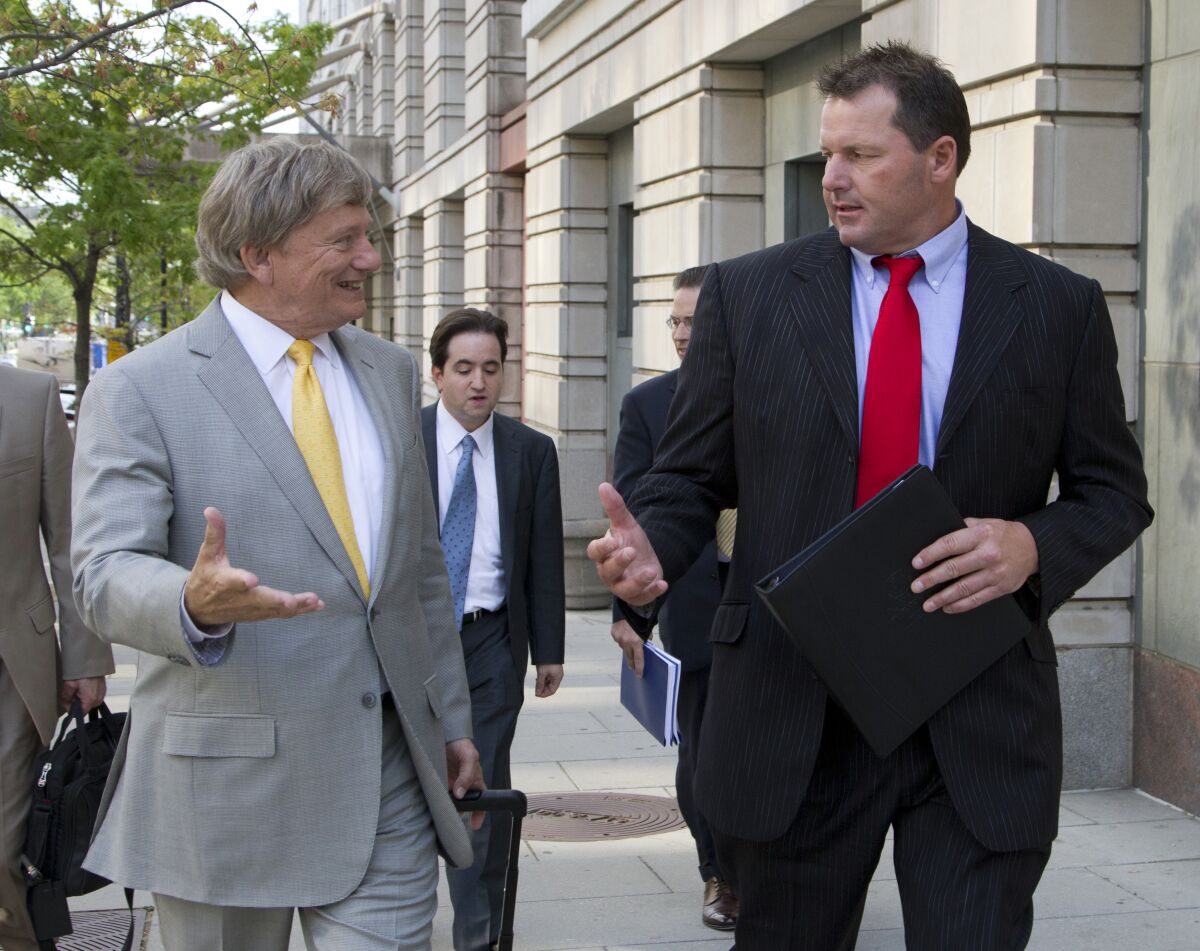 Roger Clemens, right, and attorney Rusty Hardin exit federal courthouse April 17, 2012 in Washington.
