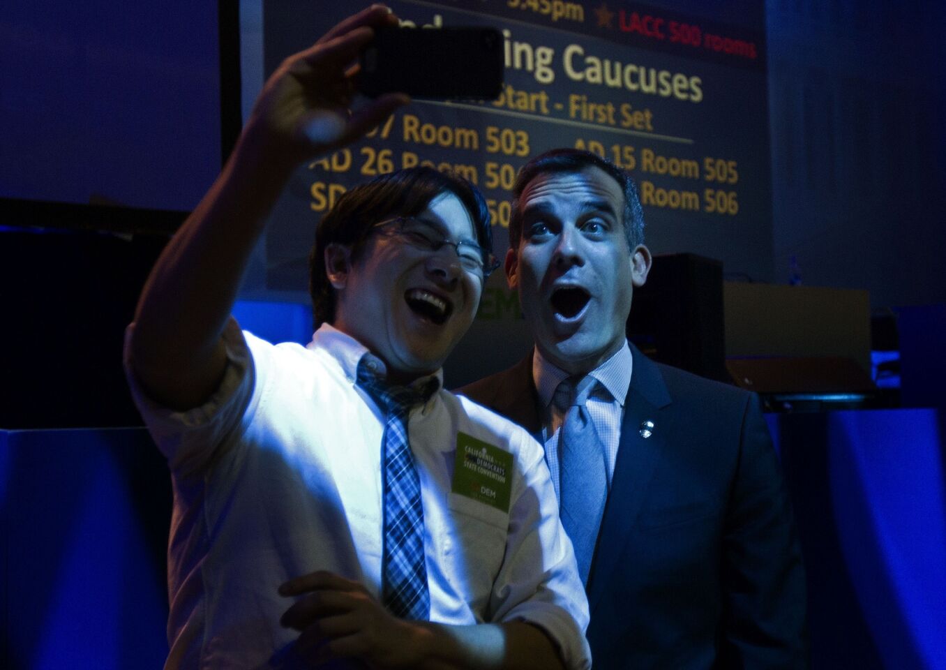 Los Angeles Mayor Eric Garcetti, right, takes a selfie with supporter Tom Nakanishi during the California Democratic Convention.