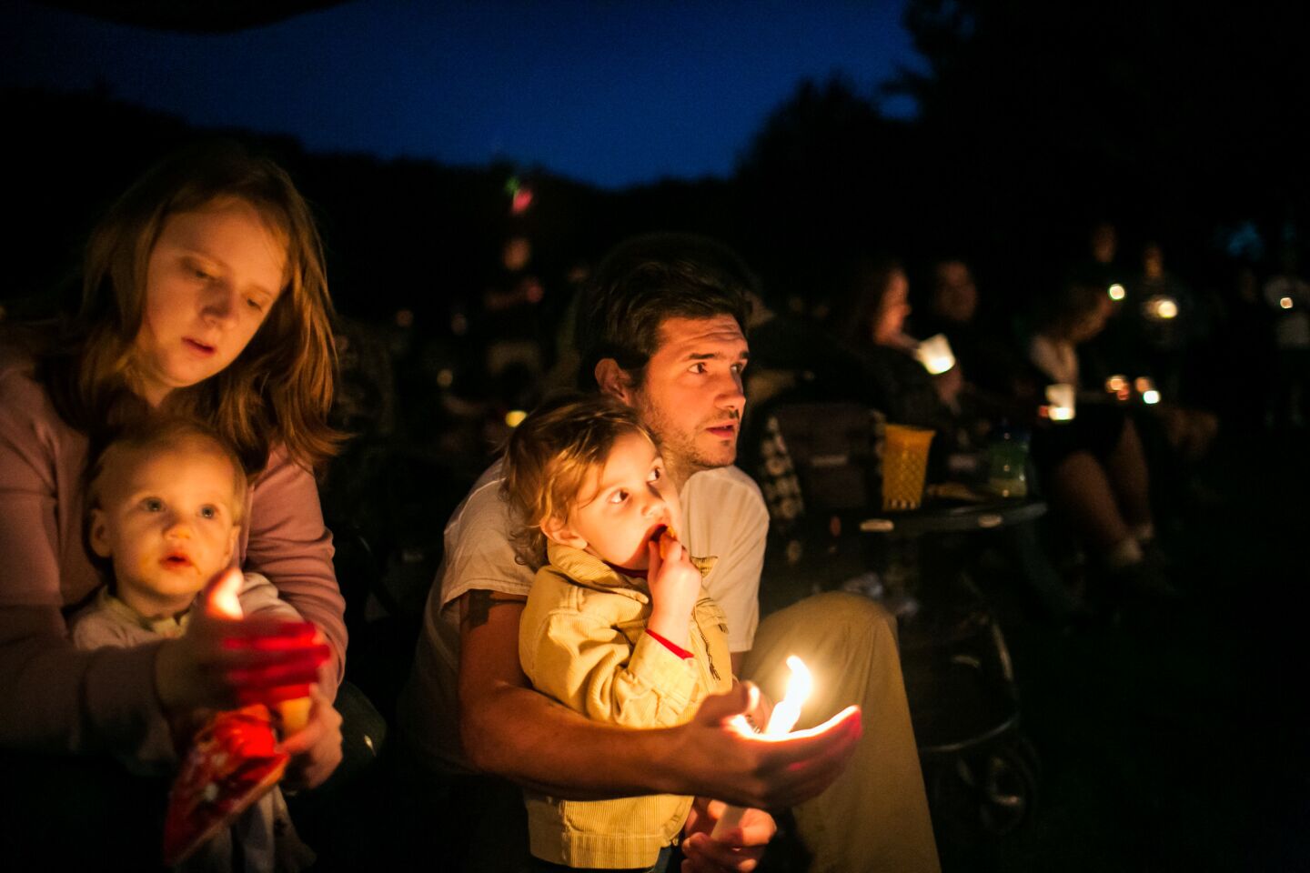 Christina and Kyle Workman attend a vigil on Oct. 3 at Riverbend Park in Winston, Ore., for victims of the mass shooting.