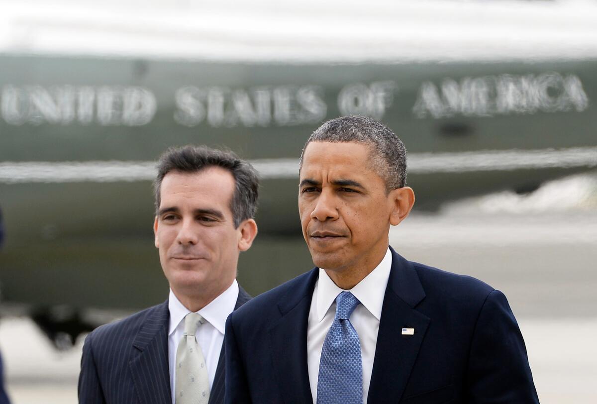 President Obama walks with Los Angeles Mayor-elect Eric Garcetti upon his arrival at Santa Monica Airport.