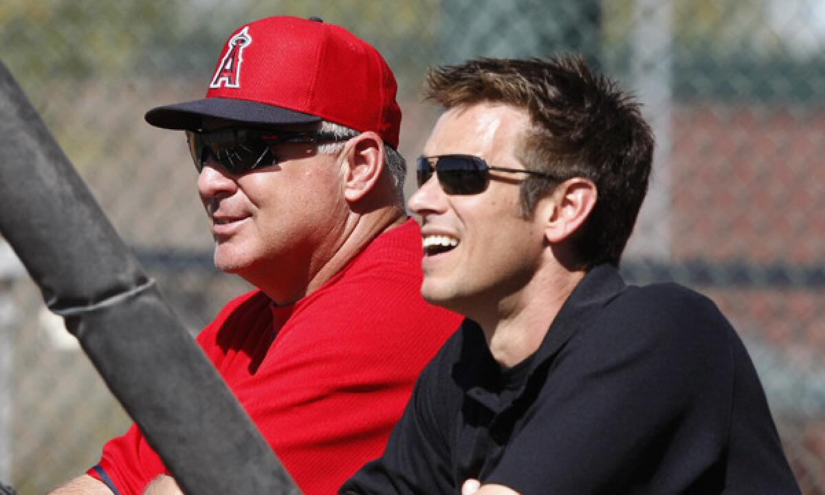 Angels Manager Mike Scioscia, left, and General Manager Jerry Dipoto watch batting practice at the team's spring training facility in Tempe, Ariz., on Feb. 20. Dipoto is under pressure to make the Angels a more successful team in 2014.