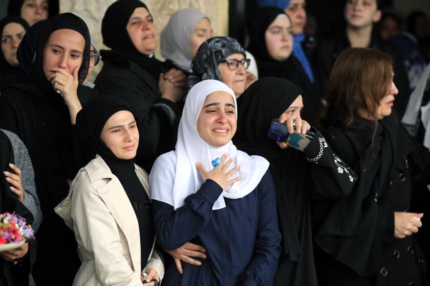 Women mourn during the funeral procession of paramedics who were killed in an Israeli airstrike, in Hebbariye village, south Lebanon, Wednesday, March 27, 2024. The Israeli airstrike on a paramedic center linked to a Lebanese Sunni Muslim group killed several people of its members. The strike was one of the deadliest single attacks since violence erupted along the Lebanon-Israel border more than five months ago. (AP Photo/Mohammed Zaatari)