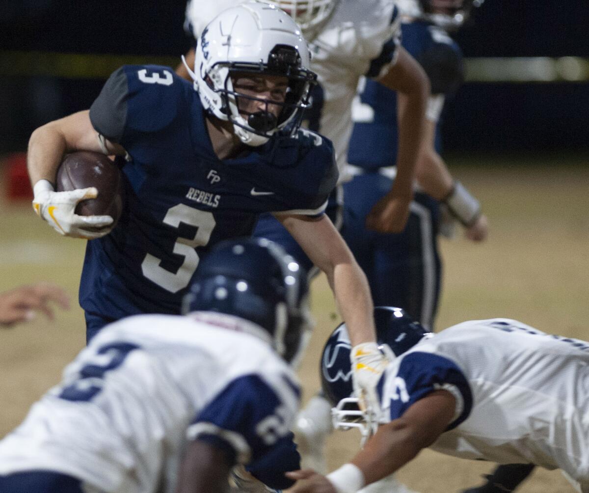 Flintridge Prep’s Kevin Ashworth tries to avoid the tackle by PAL Academy’s Tamajae Smiler during Friday's CIF Southern Section Division I playoff game at Flintridge Prep. (Photo by Miguel Vasconcellos)