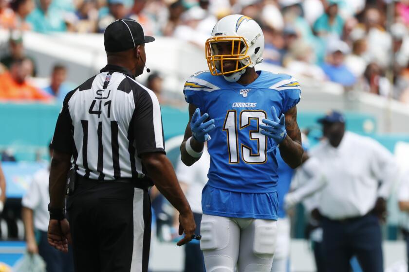 Los Angeles Chargers wide receiver Keenan Allen (13) argues a call with side judge Anthony Jeffries, during the first half at an NFL football game against the Miami Dolphins, Sunday, Sept. 29, 2019, in Miami Gardens, Fla. Allen's touchdown was nullified due to offensive pass interference, (AP Photo/Wilfredo Lee)