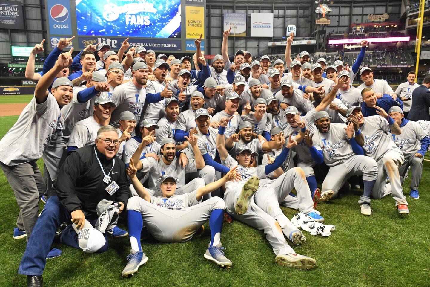 The Dodgers pose for pictures after beating the Brewers in game seven of the National League Championship Series against the Milwaukee Brewers at Miller Park.