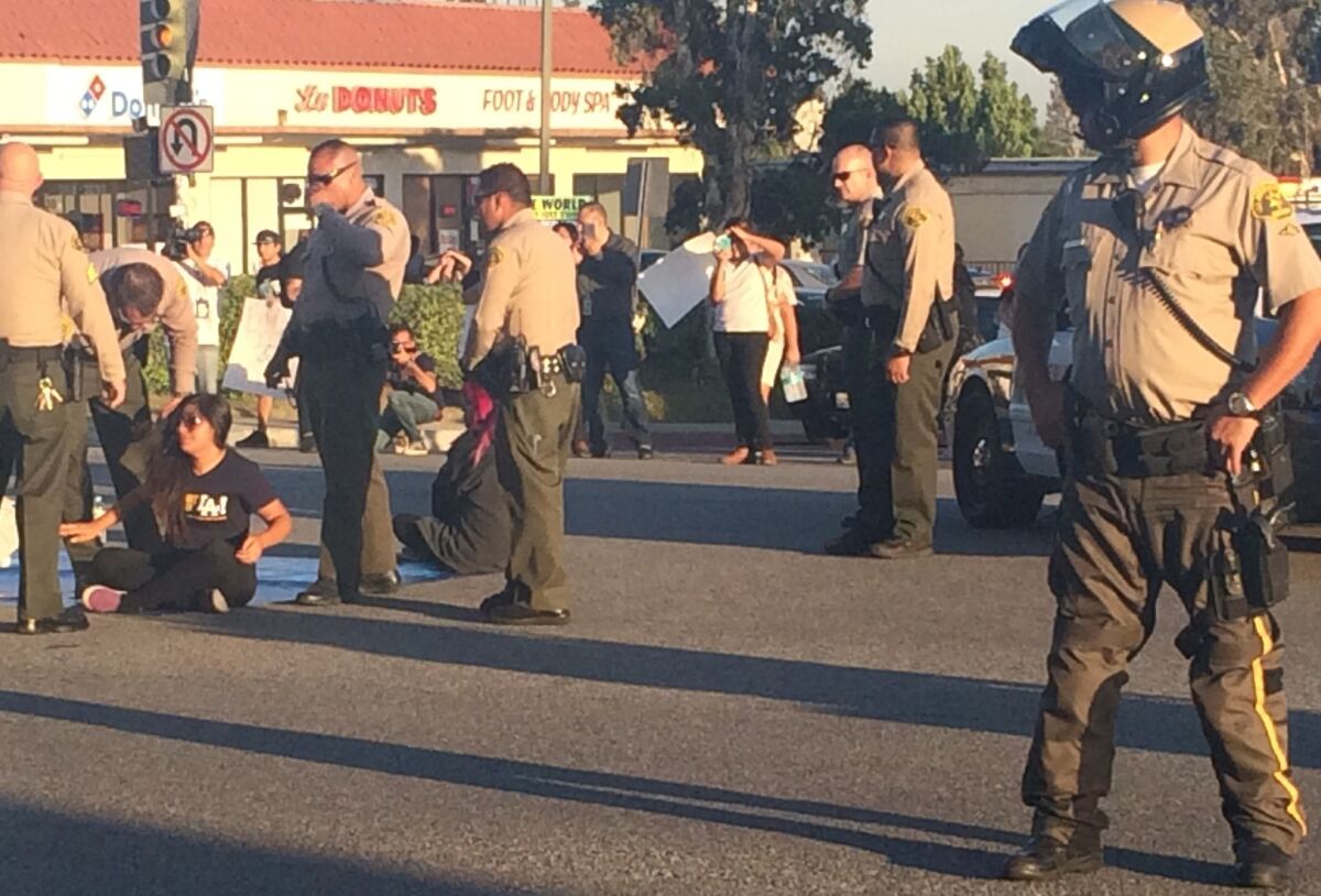Three protesters opposed to Los Angeles County jails collaborating with ICE were arrested Wednesday after they blocked traffic at Highland Avenue and Huntington Drive in Duarte.