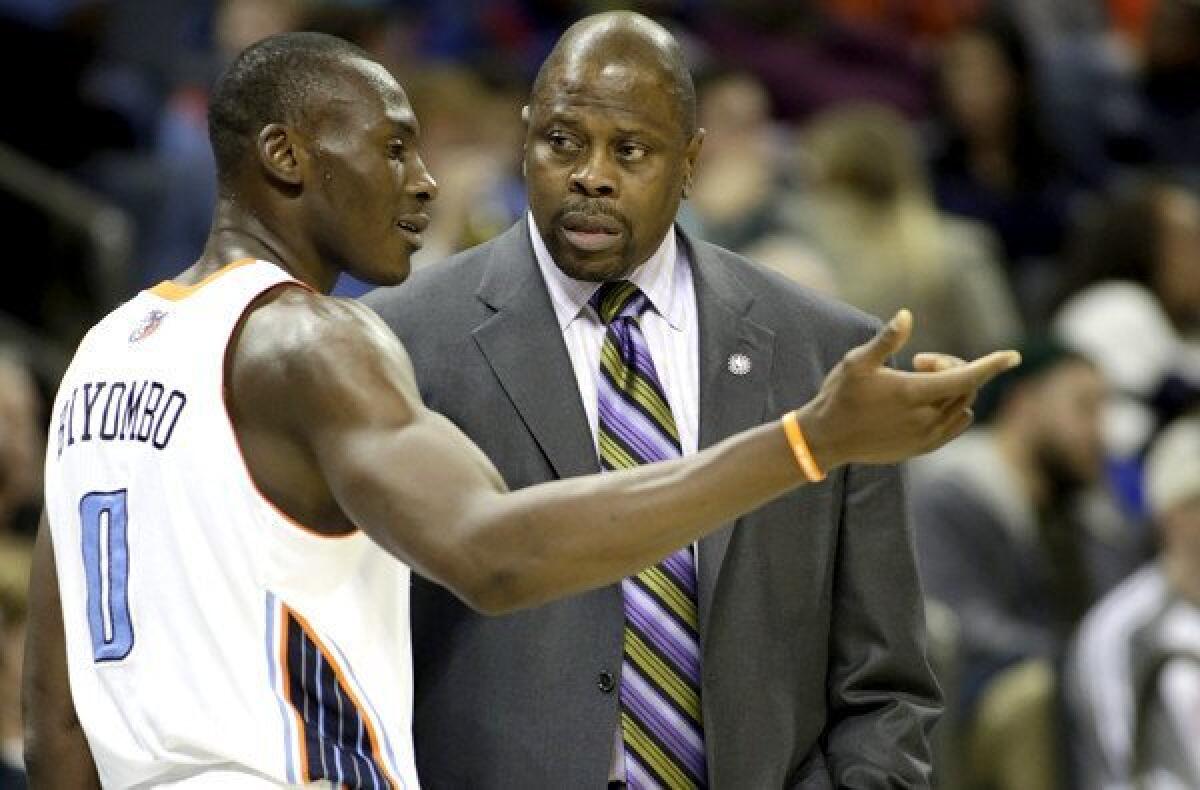 Charlotte Bobcats center Bismack Biyombo talks with acting head coach Patrick Ewing in the first half Friday night.
