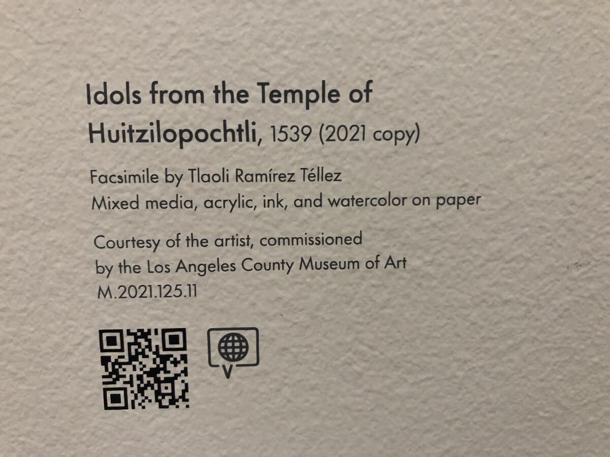 A QR code is shown nestled under wall text that reads "Idols From the Temple of Huitzilopochtli."
