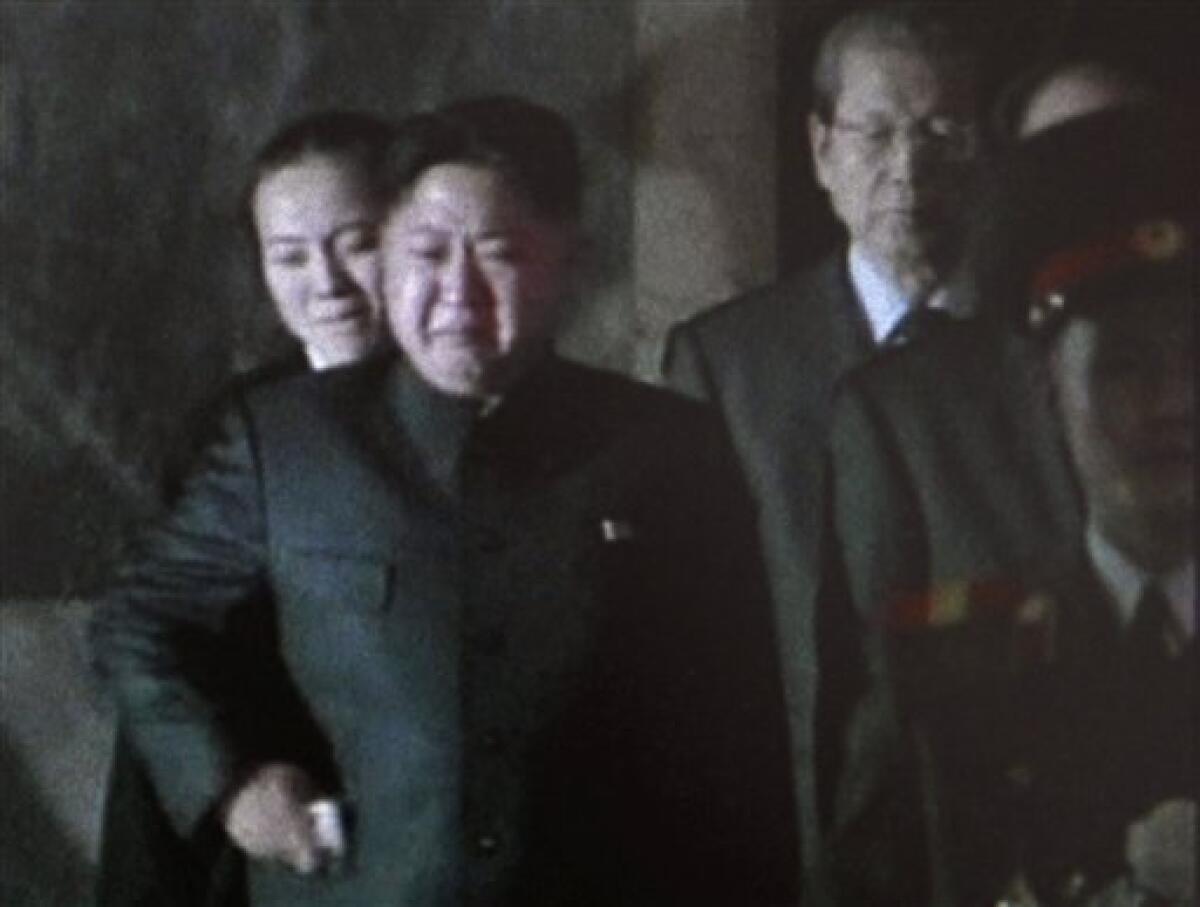 In this Dec. 26, 2011 image made from KRT television, Kim Jong Un, center, North Korea's next leader and the son of late leader Kim Jong Il, cries as he pays respect to the body of his father in a glass coffin, not in photo, at Kumsusan Memorial Palace in Pyongyang, North Korea. (AP Photo/KRT via APTN) TV OUT, NORTH KOREA OUT