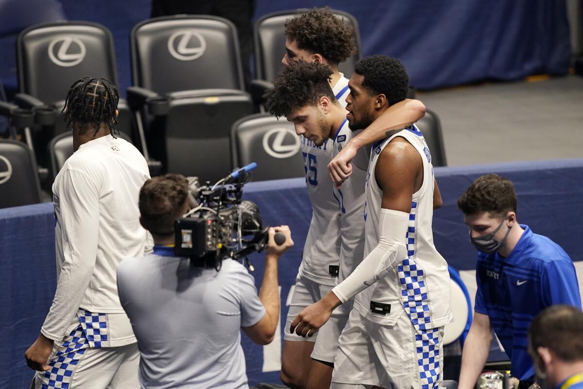 Kentucky players leave the court after losing to Mississippi State in an NCAA college basketball game in the Southeastern Conference Tournament Thursday, March 11, 2021, in Nashville, Tenn. (AP Photo/Mark Humphrey)